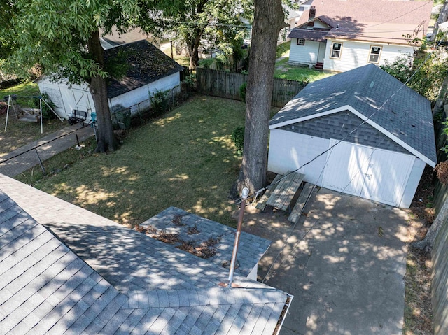 exterior space with a fenced backyard and an outbuilding