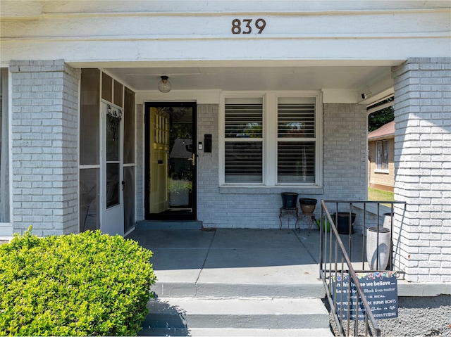 property entrance with brick siding