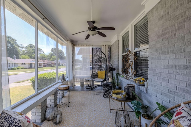 sunroom / solarium featuring a ceiling fan