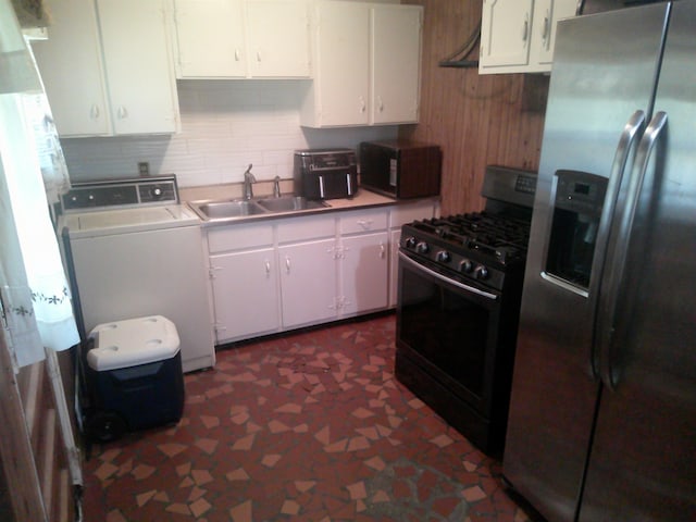 kitchen featuring washer / clothes dryer, black appliances, sink, and white cabinetry