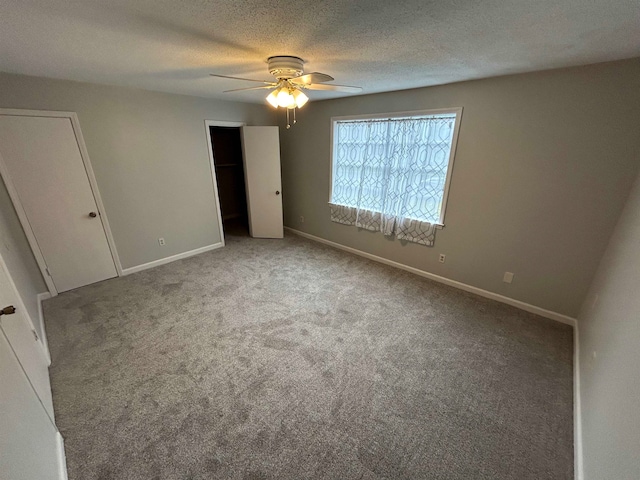 unfurnished bedroom featuring carpet flooring, a textured ceiling, and ceiling fan