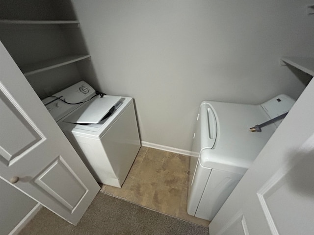 laundry area featuring washing machine and clothes dryer and carpet floors