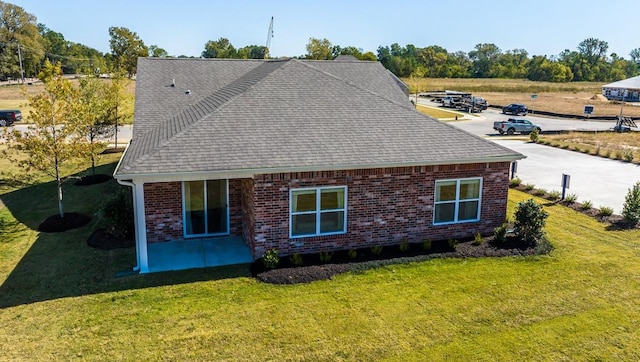 4507 Shelby Rd, Millington, TN 38053 - view of side of home with brick siding, a lawn, and roof with shingles