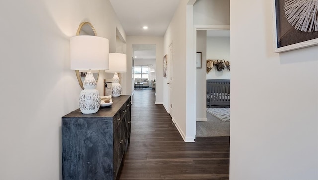 hall with dark wood-style floors, recessed lighting, and baseboards