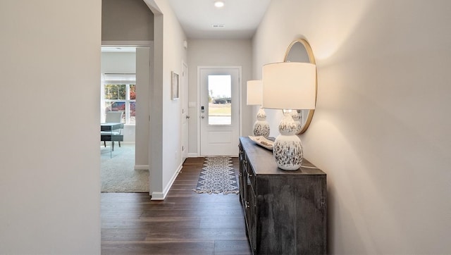 entryway with visible vents, baseboards, and dark wood-style flooring