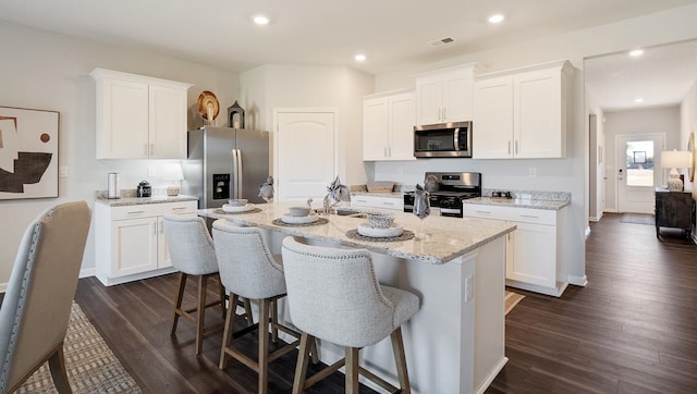 4507 Shelby Rd, Millington, TN 38053 - kitchen with recessed lighting, a breakfast bar, a sink, appliances with stainless steel finishes, and dark wood finished floors