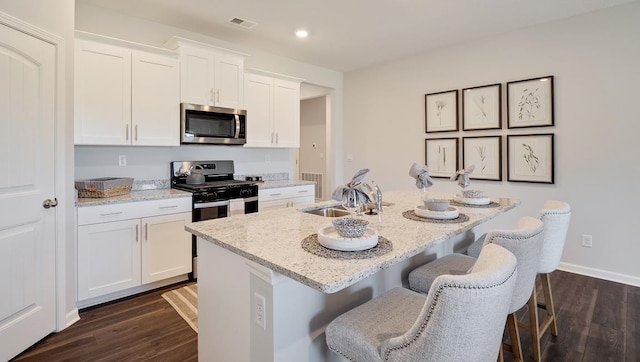 4507 Shelby Rd, Millington, TN 38053 - kitchen with stainless steel appliances, dark wood-style flooring, a sink, visible vents, and white cabinets