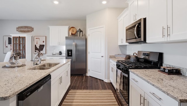 4507 Shelby Rd, Millington, TN 38053 - kitchen with dark wood-style floors, appliances with stainless steel finishes, white cabinetry, a sink, and recessed lighting