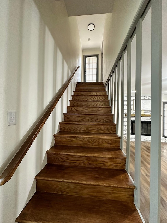 staircase with wood finished floors