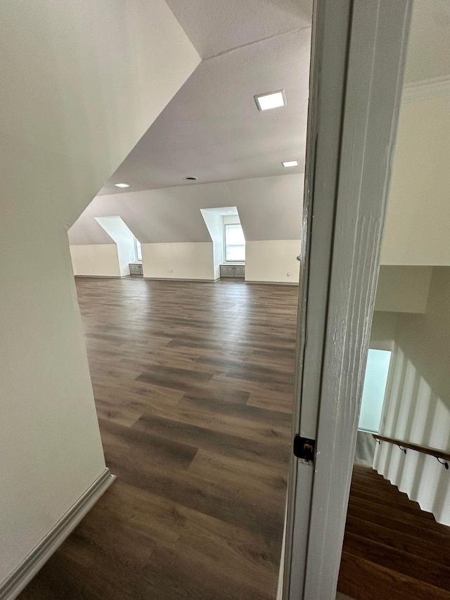 additional living space with lofted ceiling and wood finished floors