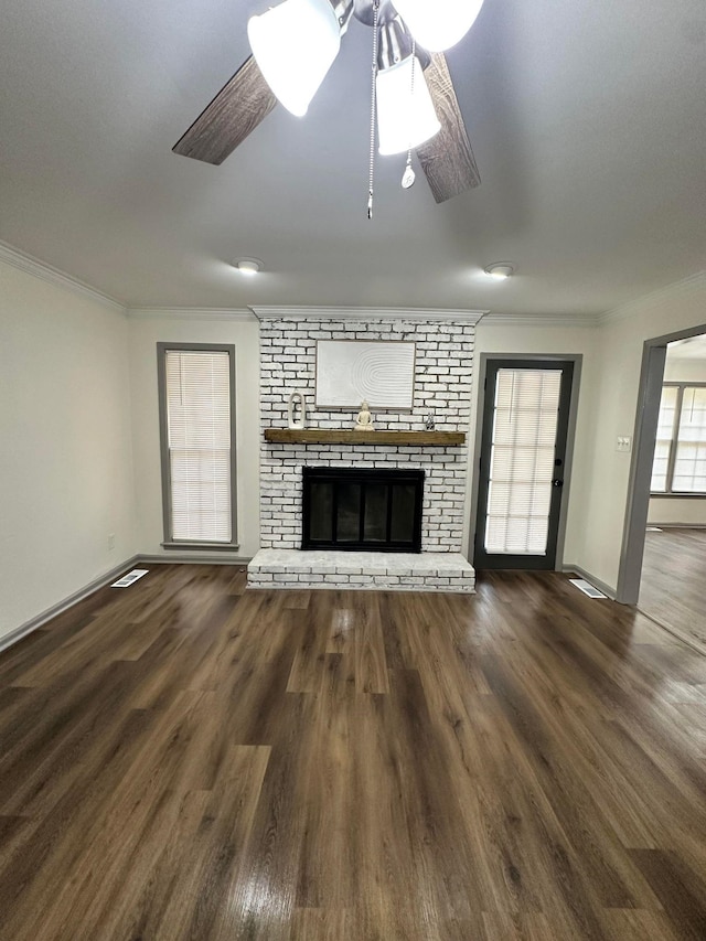 unfurnished living room with baseboards, crown molding, and wood finished floors
