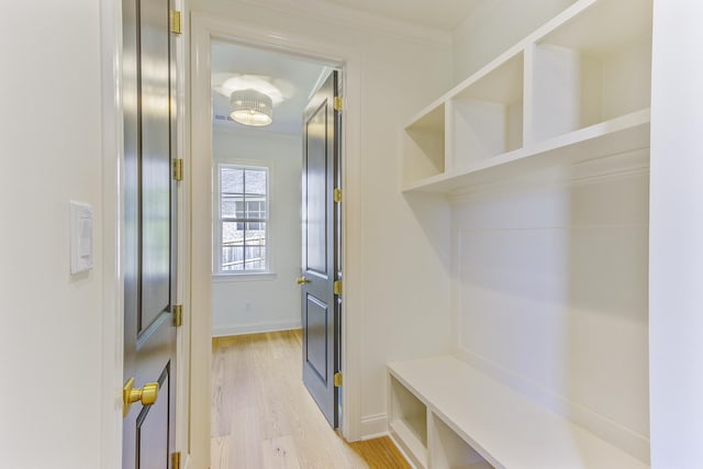 mudroom with light hardwood / wood-style flooring and ornamental molding