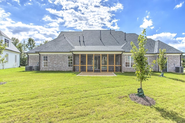 back of property featuring a sunroom, cooling unit, and a yard