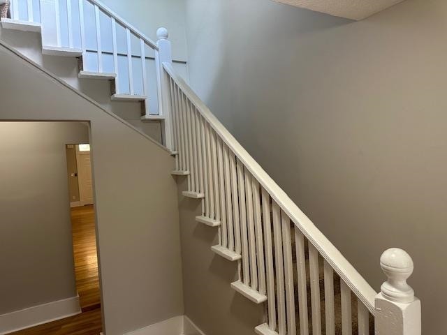 stairway with hardwood / wood-style floors