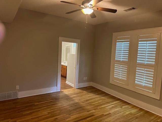 spare room featuring hardwood / wood-style floors and ceiling fan