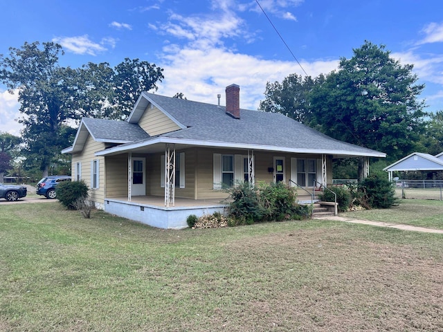 view of front of property with covered porch and a front yard