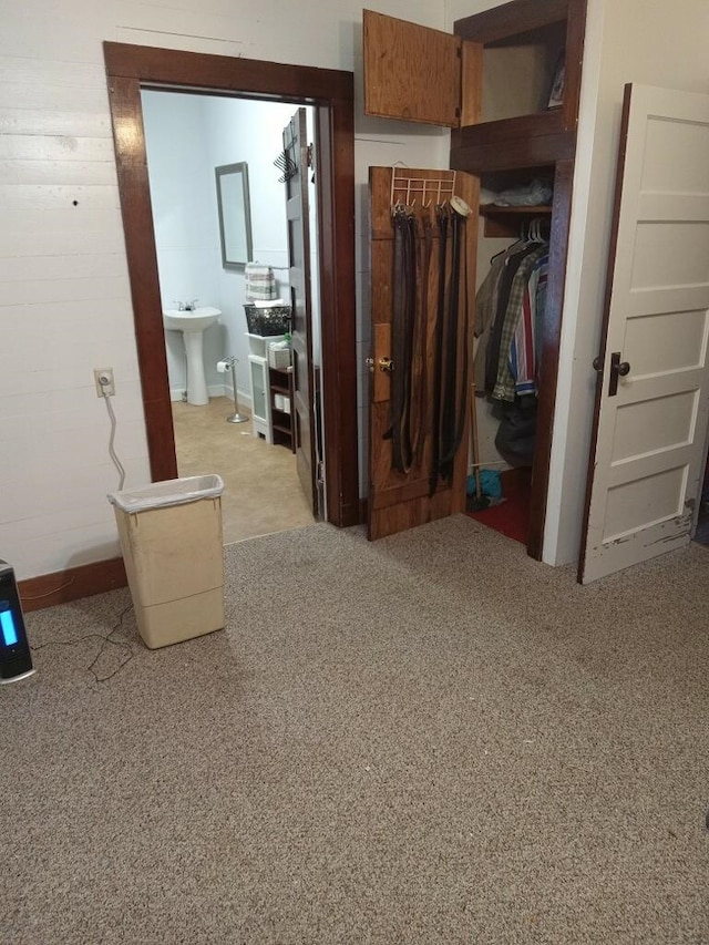 corridor with carpet and a sink