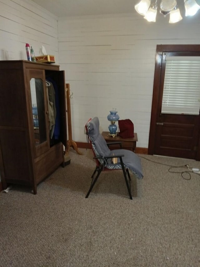 sitting room featuring ornamental molding and carpet