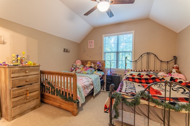 bedroom featuring light colored carpet, vaulted ceiling, and ceiling fan