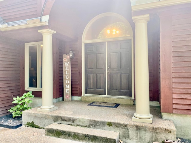 view of exterior entry featuring covered porch