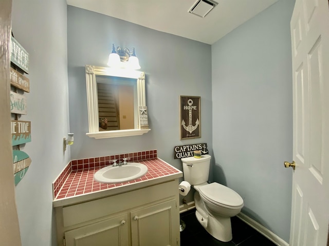 bathroom with vanity, toilet, and tile patterned floors