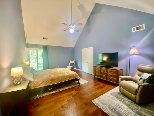 bedroom featuring dark wood-type flooring, high vaulted ceiling, and ceiling fan