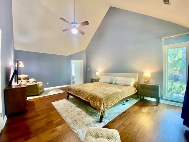 bedroom featuring high vaulted ceiling, ceiling fan, wood-type flooring, and multiple windows