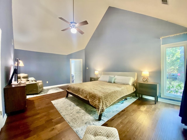 bedroom with ceiling fan, high vaulted ceiling, visible vents, wood finished floors, and baseboards