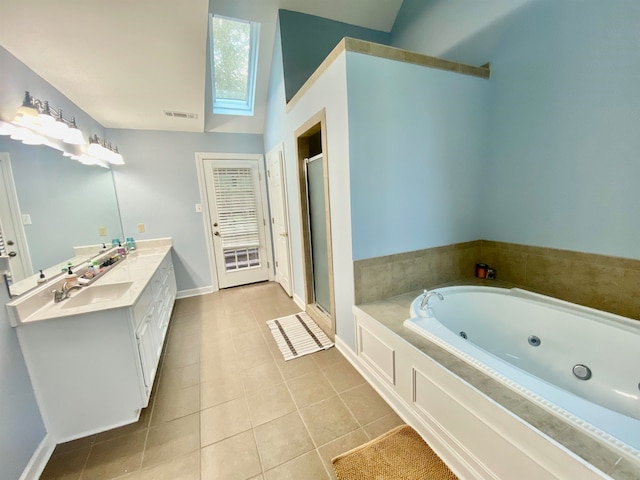 bathroom with tile patterned flooring, vanity, and separate shower and tub