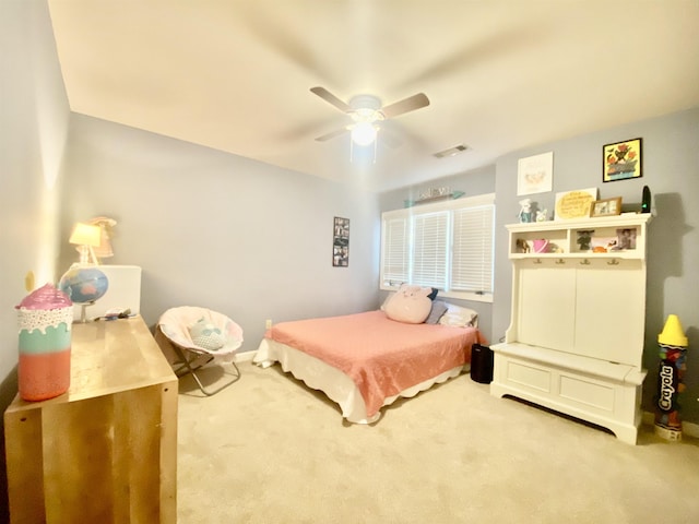 bedroom with visible vents, a ceiling fan, and carpet flooring