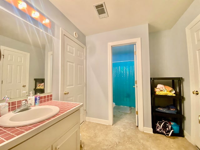 bathroom with concrete flooring, decorative backsplash, and vanity