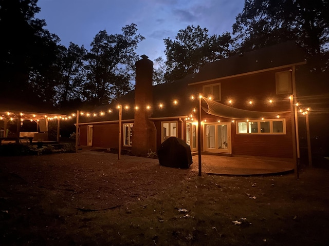 rear view of property with a patio and a chimney
