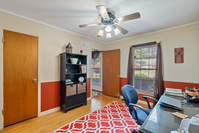 office featuring light hardwood / wood-style flooring, ceiling fan, and ornamental molding