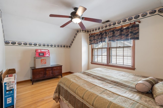 bedroom with lofted ceiling, light hardwood / wood-style flooring, and ceiling fan