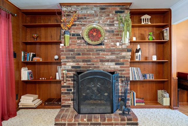 living room featuring a fireplace and crown molding