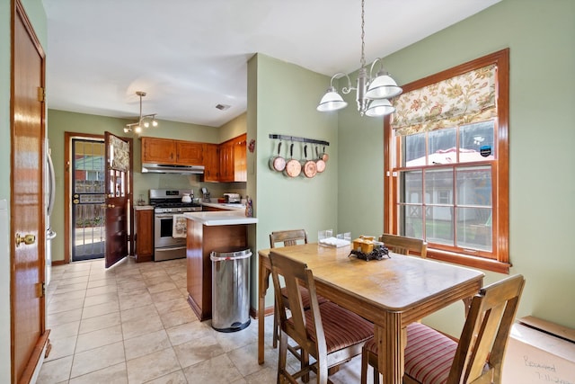 dining space featuring light tile patterned floors and a chandelier