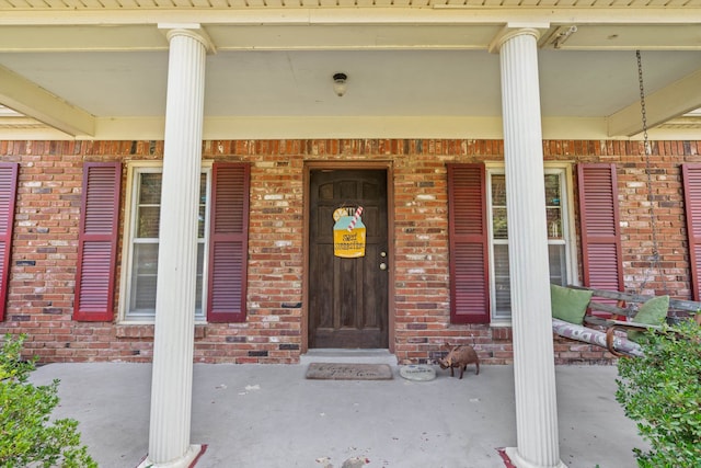 property entrance with covered porch