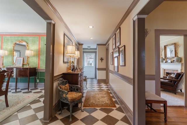 hallway featuring tile patterned floors, recessed lighting, baseboards, and ornamental molding