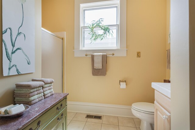 bathroom with an enclosed shower, tile patterned floors, toilet, and vanity