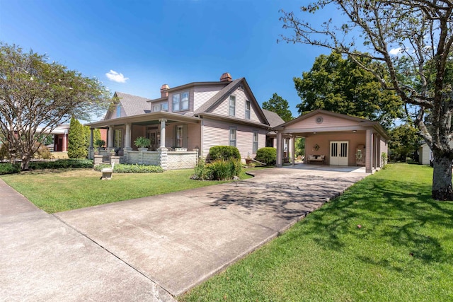 view of front facade featuring a front yard, a carport, and covered porch