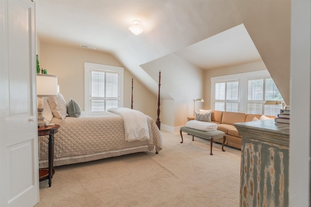 carpeted bedroom with visible vents and lofted ceiling