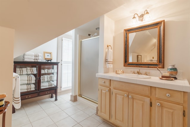 full bath with vanity, a shower stall, and tile patterned floors