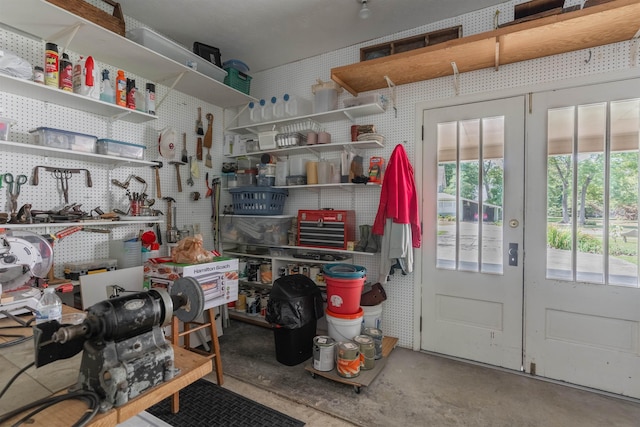 misc room featuring a workshop area, french doors, and concrete flooring