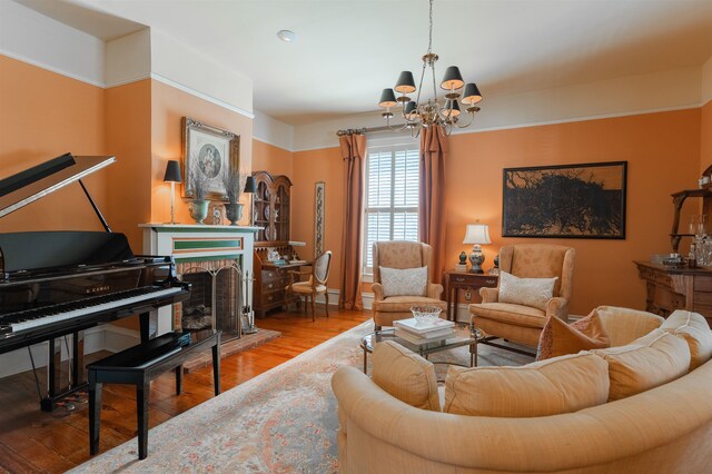 living room with a fireplace, wood-type flooring, and a notable chandelier