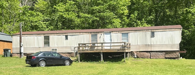 exterior space featuring a front yard and a wooden deck