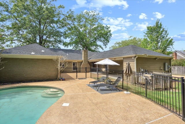 view of swimming pool with a lawn and a patio area