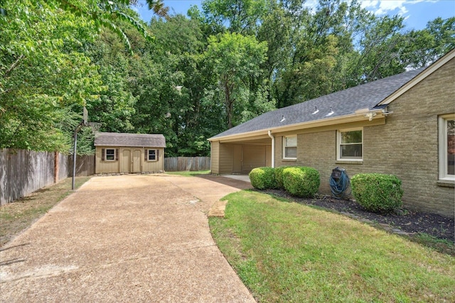 ranch-style home with a storage unit and a front lawn