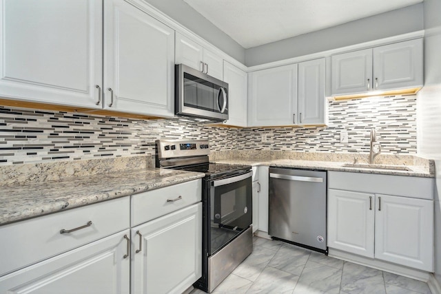 kitchen with white cabinets, stainless steel appliances, and sink