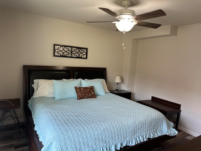 bedroom featuring ceiling fan and dark hardwood / wood-style flooring