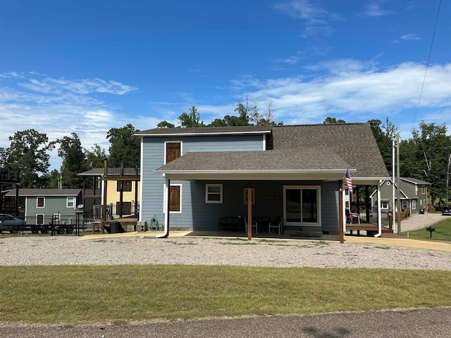 rear view of house with a patio area and a yard